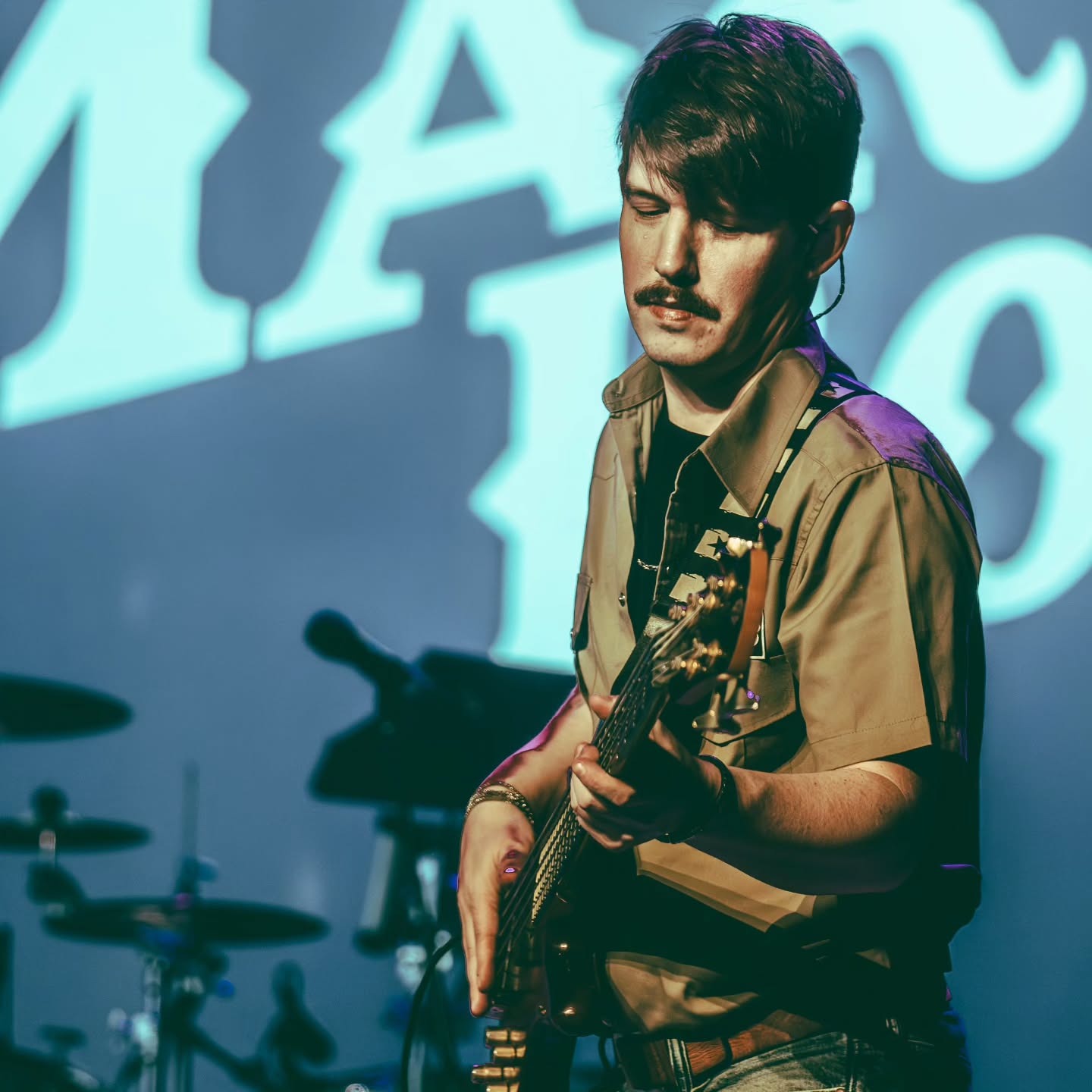 Dan Beattie bassist black shirt aviators red bass guitar